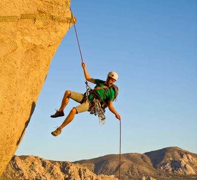 A man is rock climbing.