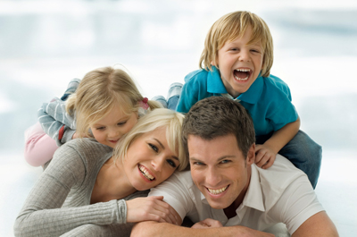 A family smiling on the floor.
