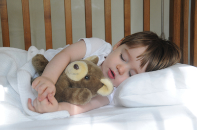 A young boy peacefully resting with a teddy bear in an auto draft.